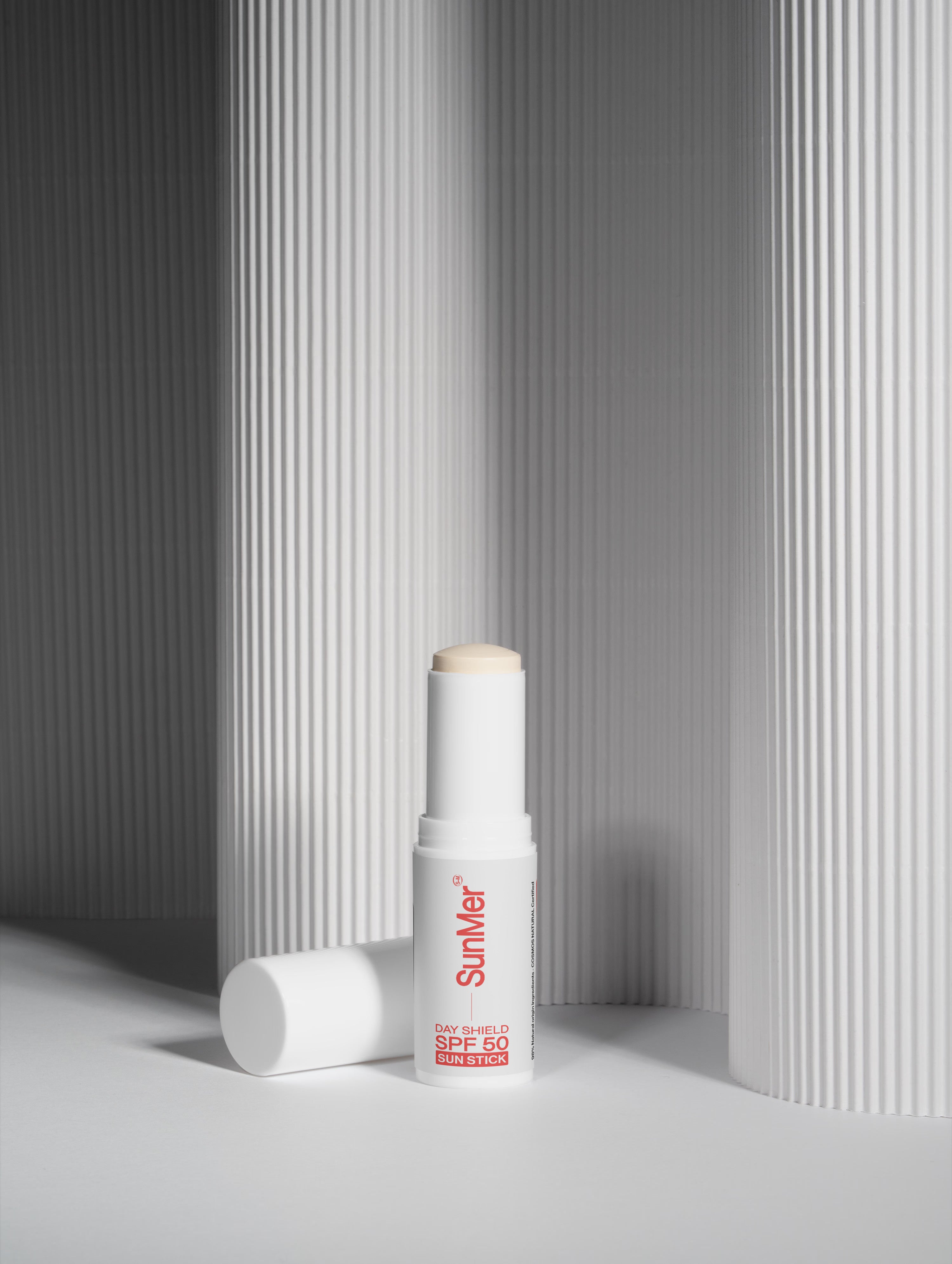 Sunscreen stick with 'SunMer' branding on a gray background